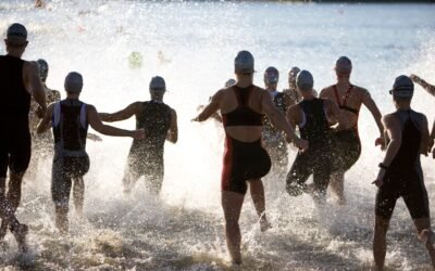 Triathlonisci wbiegajacy do wody na starcie