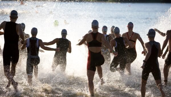 Triathlonisci na starcie plywania w otwartej wodzie